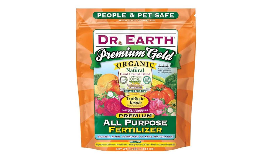 Dr. Earth Premium Gold All Purpose Fertilizer package. The package is orange with green and white accents. It is labeled as organic and natural with a 4-4-4 nutrient ratio. The package also mentions it is people and pet safe when used as directed. It is ideal for vegetables, all flowers, potted plants, bedding plants, all trees, shrubs, annuals, and perennials. The net weight is 4 lbs (1.814 kg).