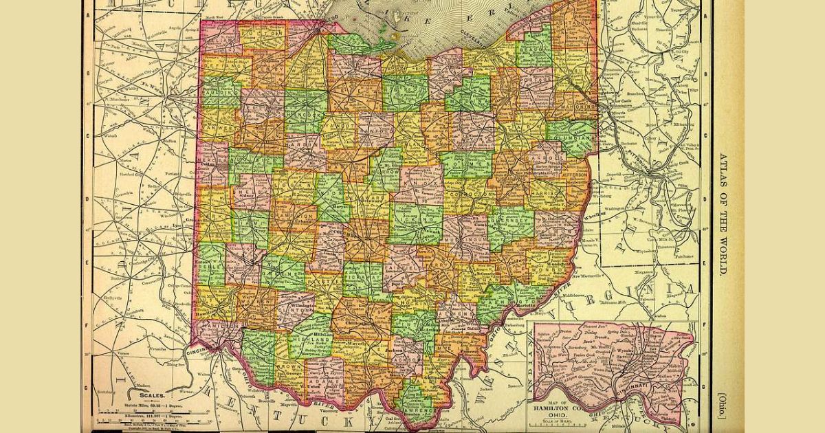 A detailed, colored map of the state of Ohio from an atlas. The map shows all the counties within Ohio, each outlined and filled with different colors for distinction. Major cities such as Cleveland, Columbus, and Cincinnati are marked. The map also includes a smaller inset map of Hamilton County, located in the bottom right corner. The surrounding states and Lake Erie are partially visible. The map is labeled Atlas of the World on the right side.